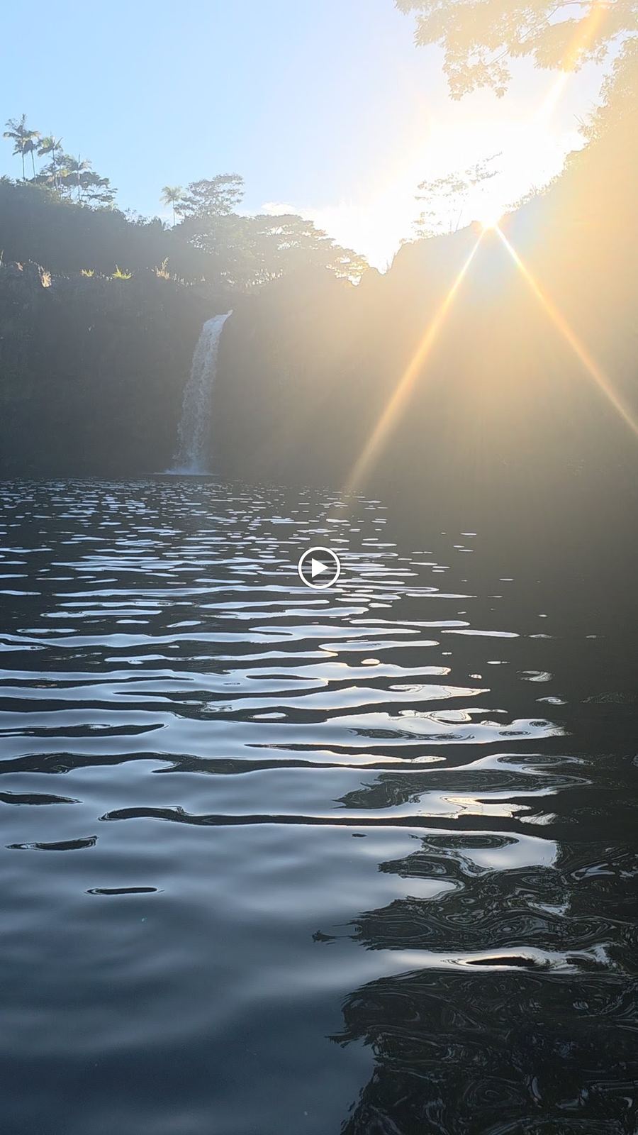 Sunlit waterfall through the trees