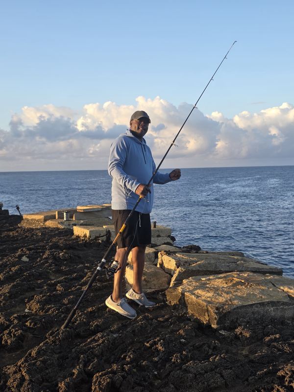 Jessie fishing from volcanic rock